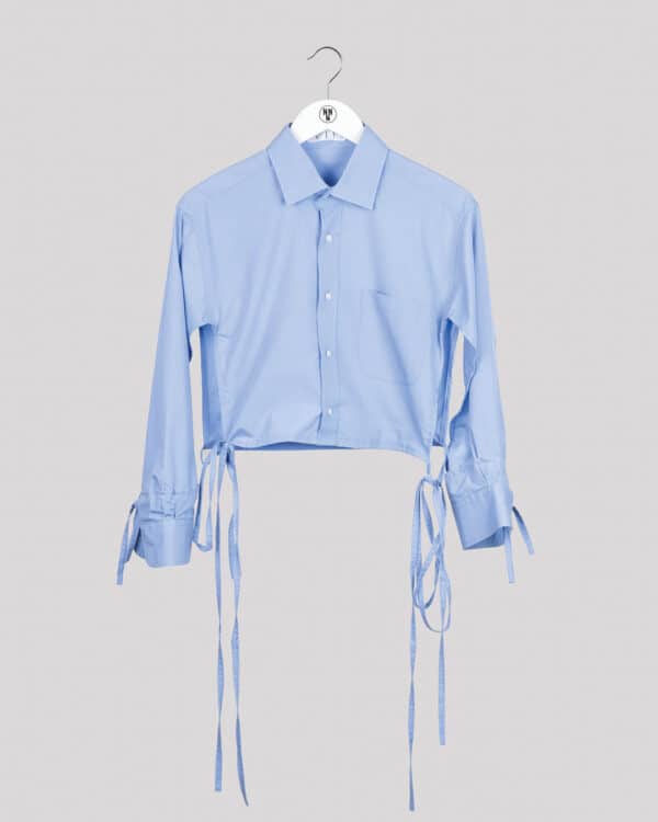 Light blue blouse with open cut and ribbons