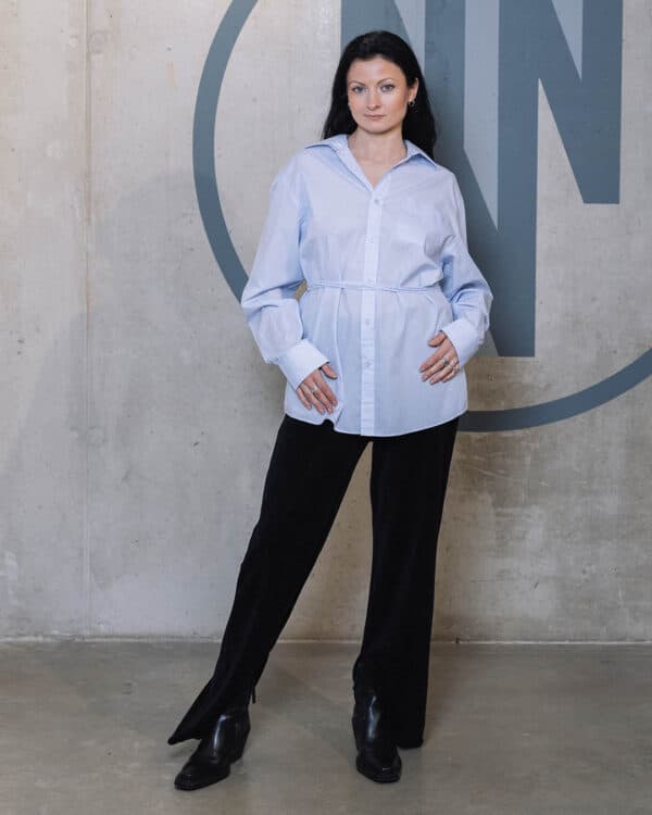 Light blue blouse with an open back and belt